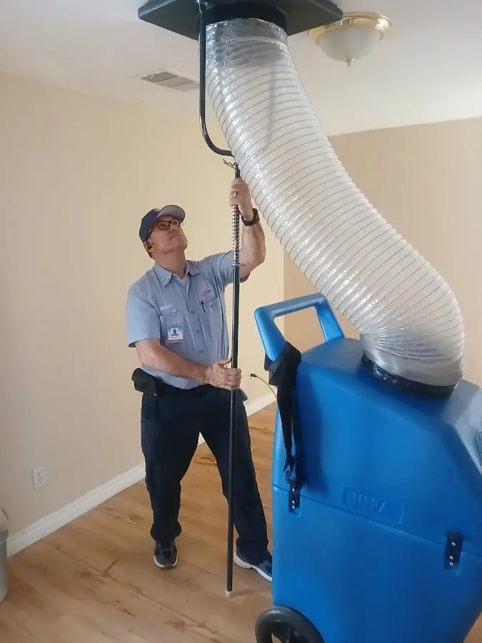 Furnace Tune-Up technician using HEPA equipment in Largo